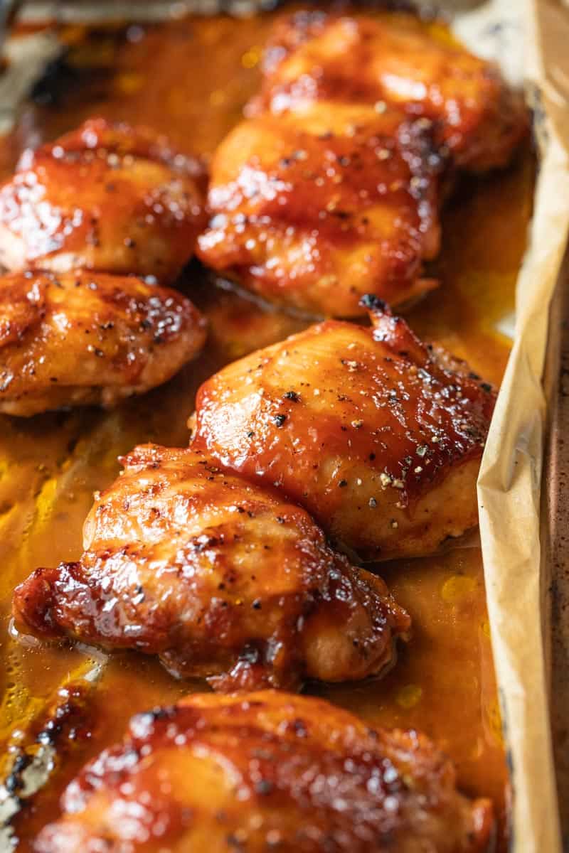 bbq boneless chicken thighs on a baking sheet