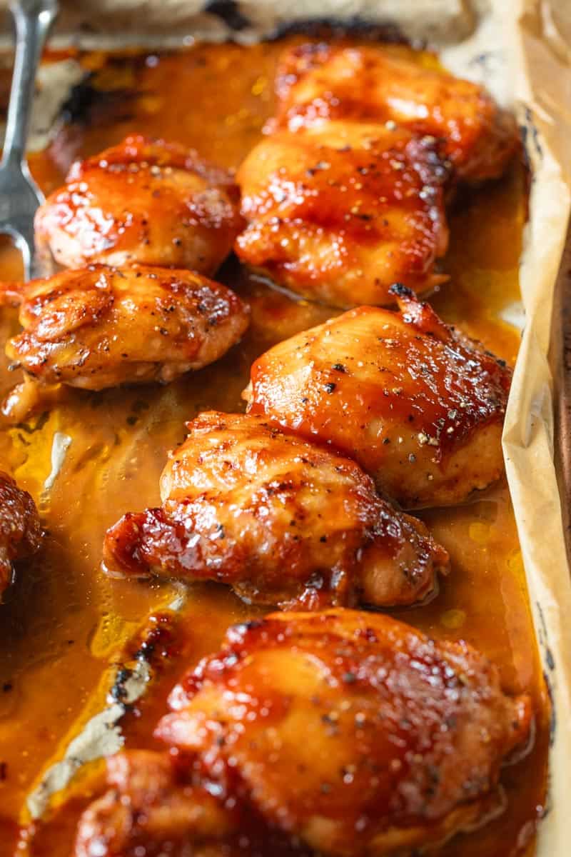 bbq smothered chicken thighs on a baking sheet