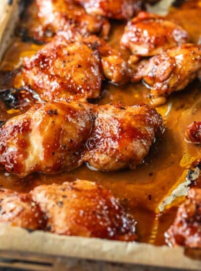 bbq boneless chicken thighs on a baking sheet