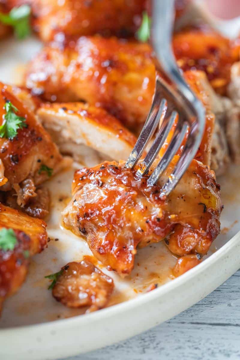 fork piercing a bite of bbq chicken