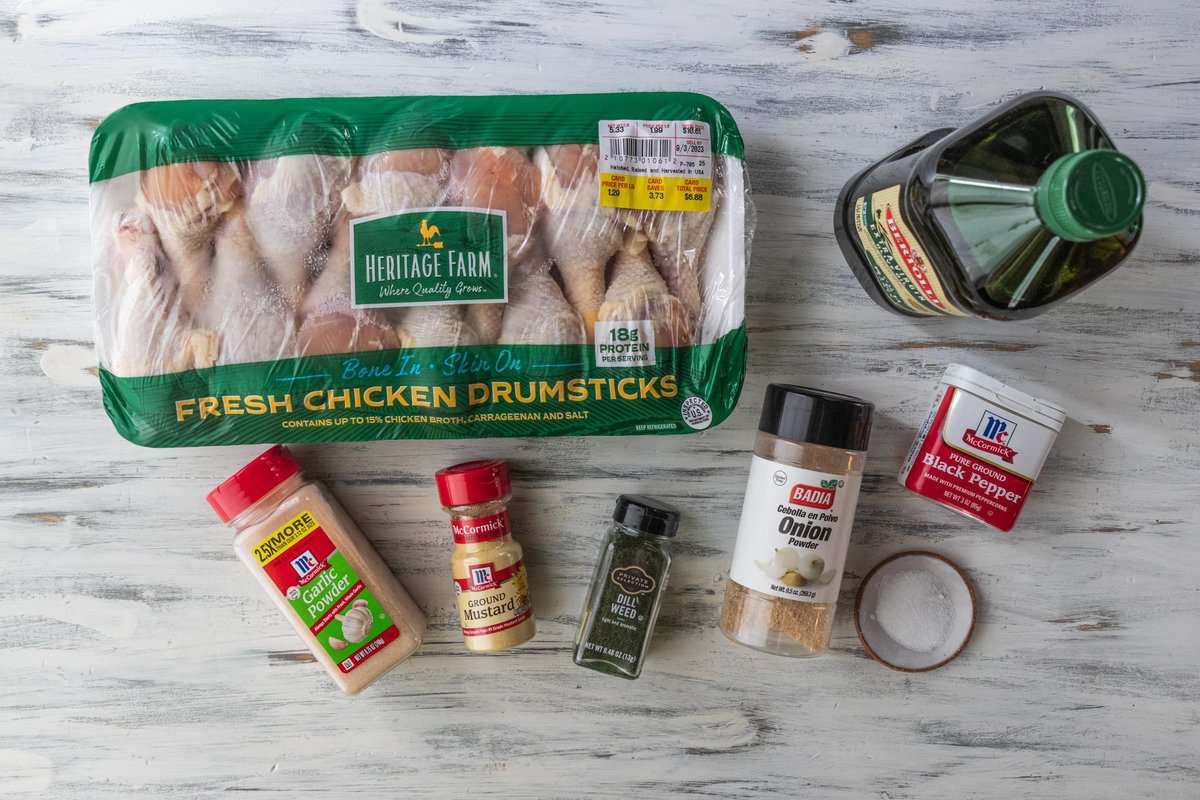 chicken drumsticks, olive oil and spices on a countertop