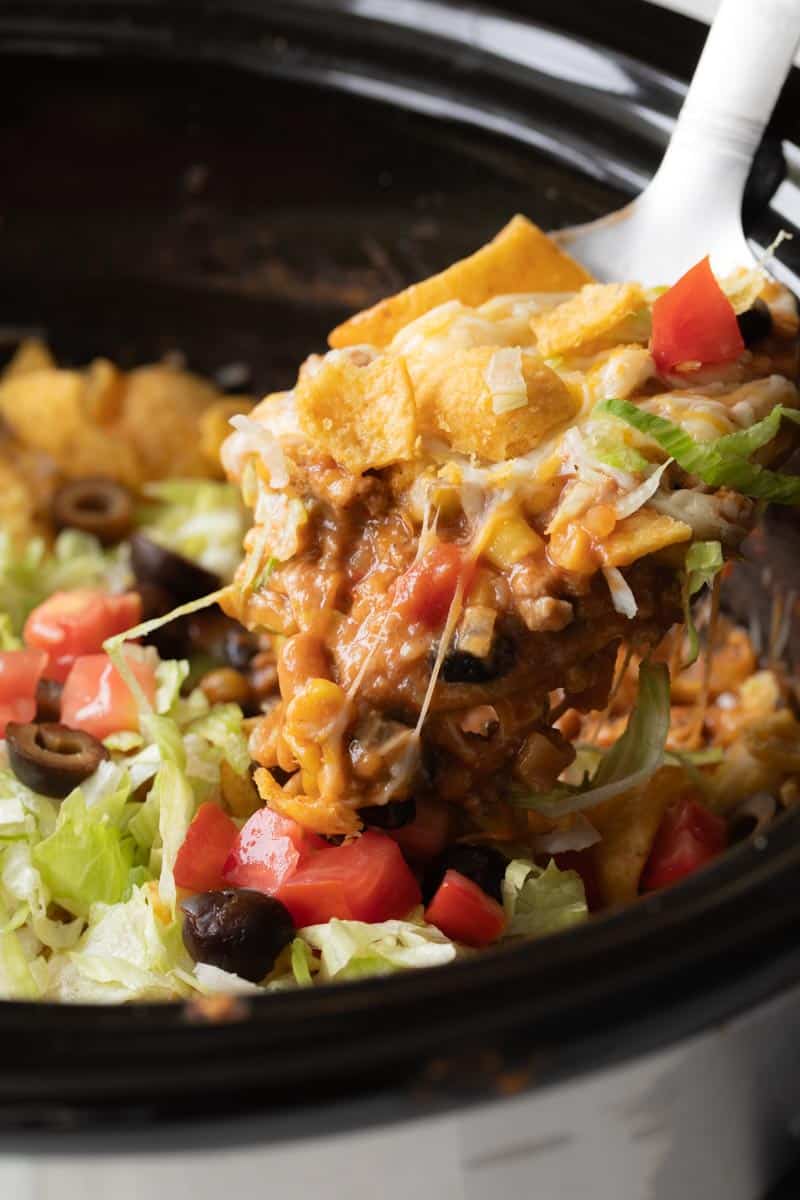 spoon scooping taco casserole from crockpot