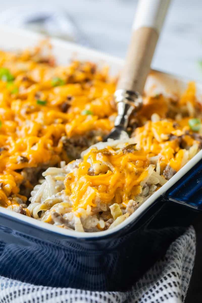 spoon in a baking dish of hamburger hashbrown casserole