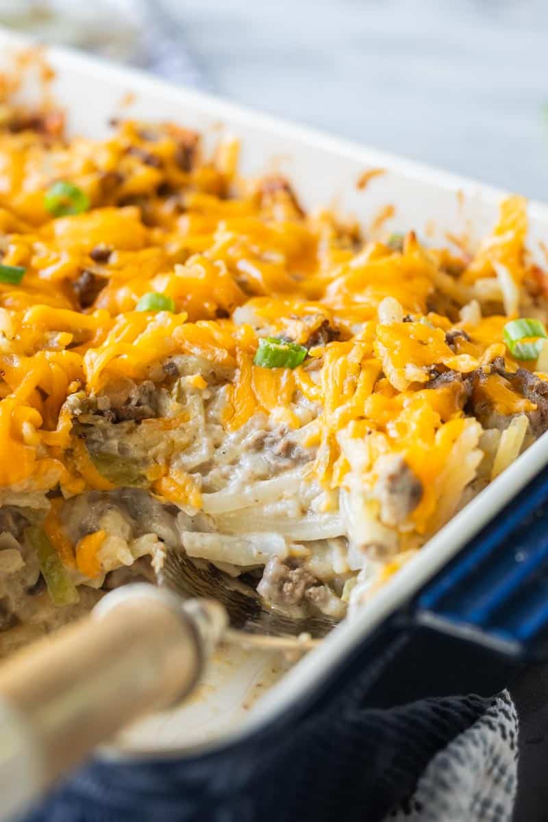 spoon in a baking dish of hamburger hashbrown casserole