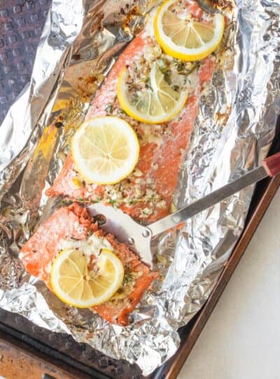 top down shot of metal spatula picking up piece of salmon