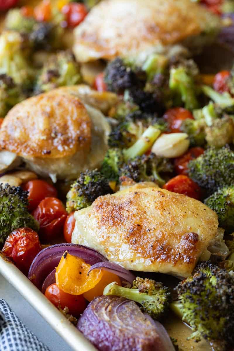 baked chicken thighs on sheet pan with roasted vegetables