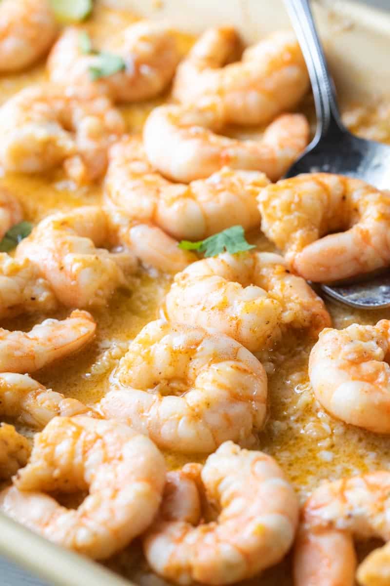 spoon on sheet pan with cooked shrimp