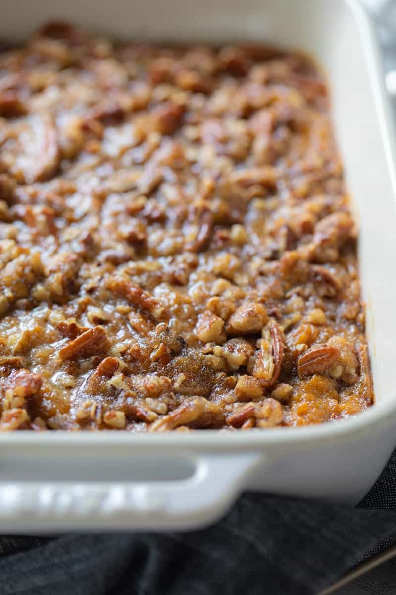 close up of sweet potato casserole in a white casserole pan