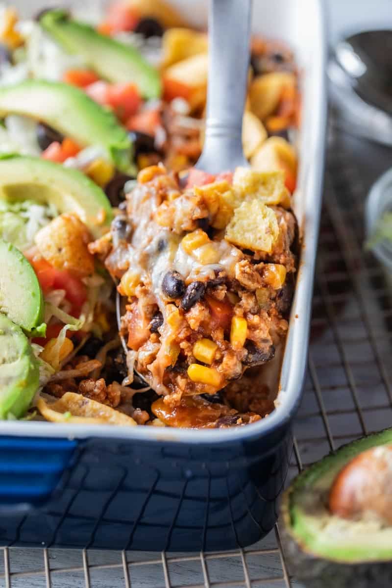 spatula scooping taco casserole from baking dish