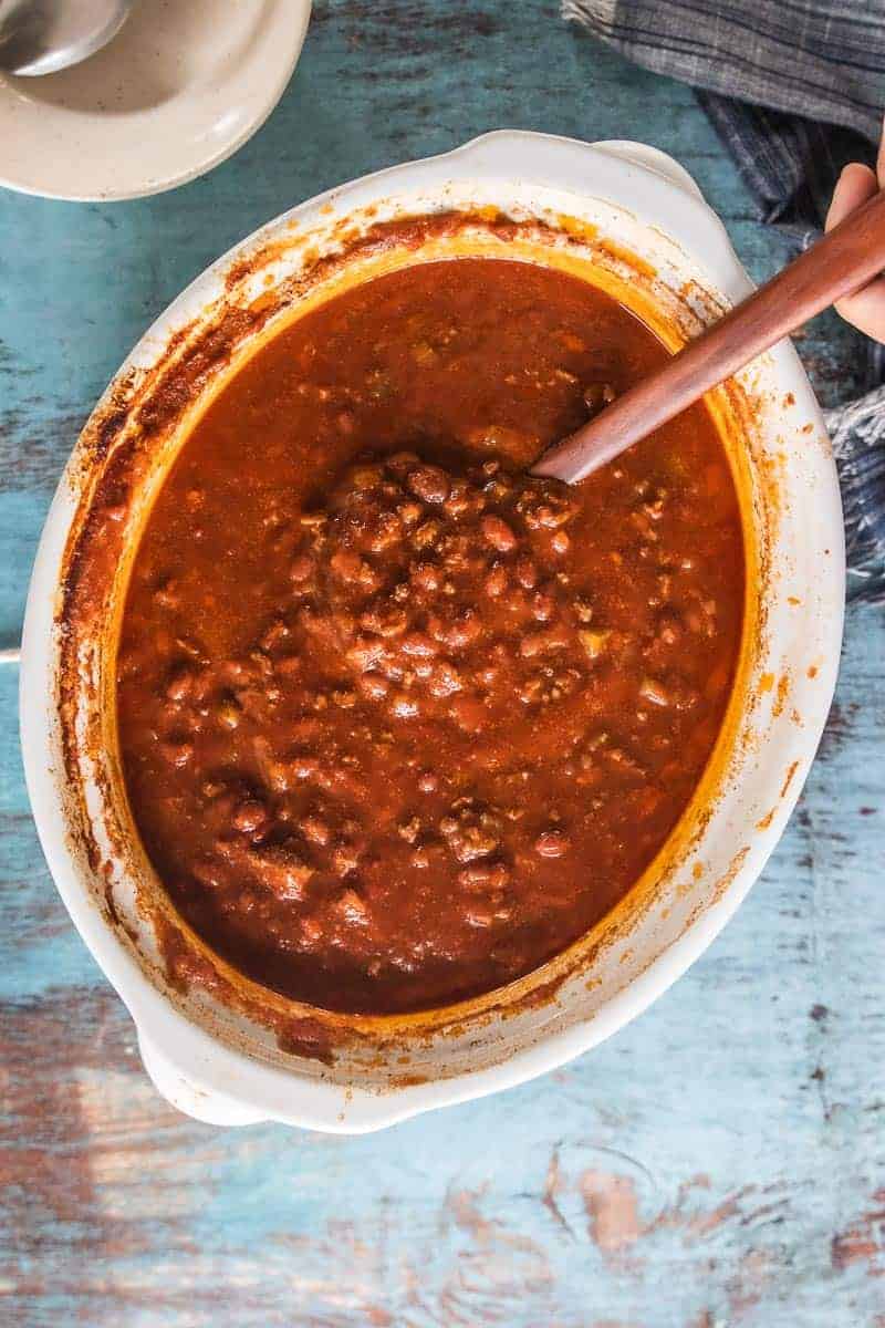 A top down view of a slow cooker with cooked chili.