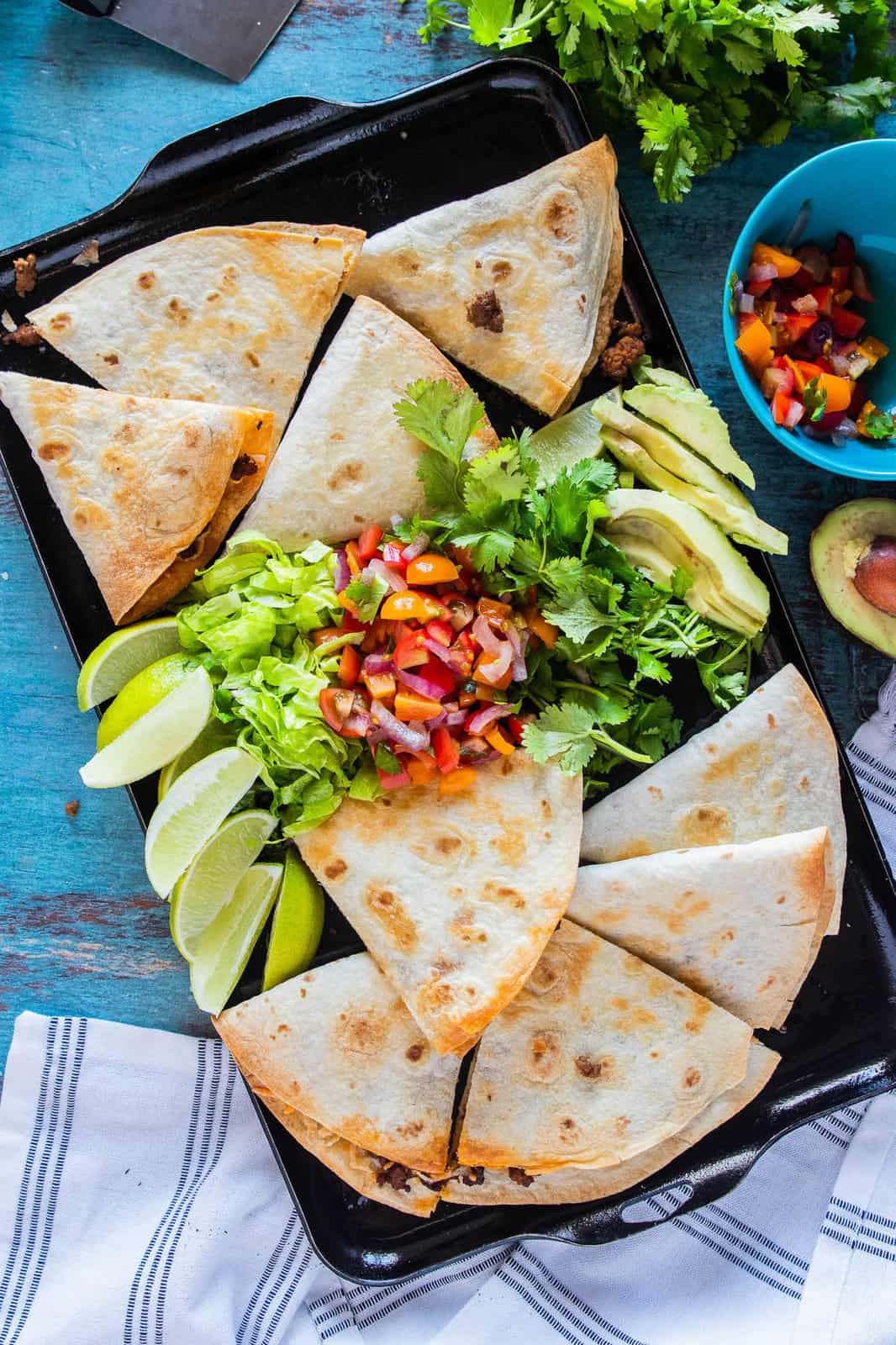 taco quesadilla on a baking sheet with garnishes