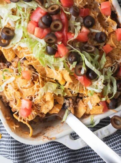 top down view of large spoon in walking taco casserole