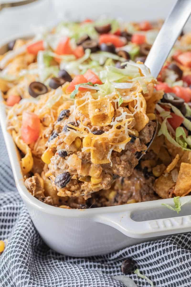 large spoon scooping taco casserole from dish