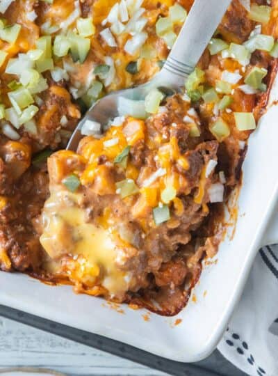spatula scooping serving of cheeseburger casserole from baking dish