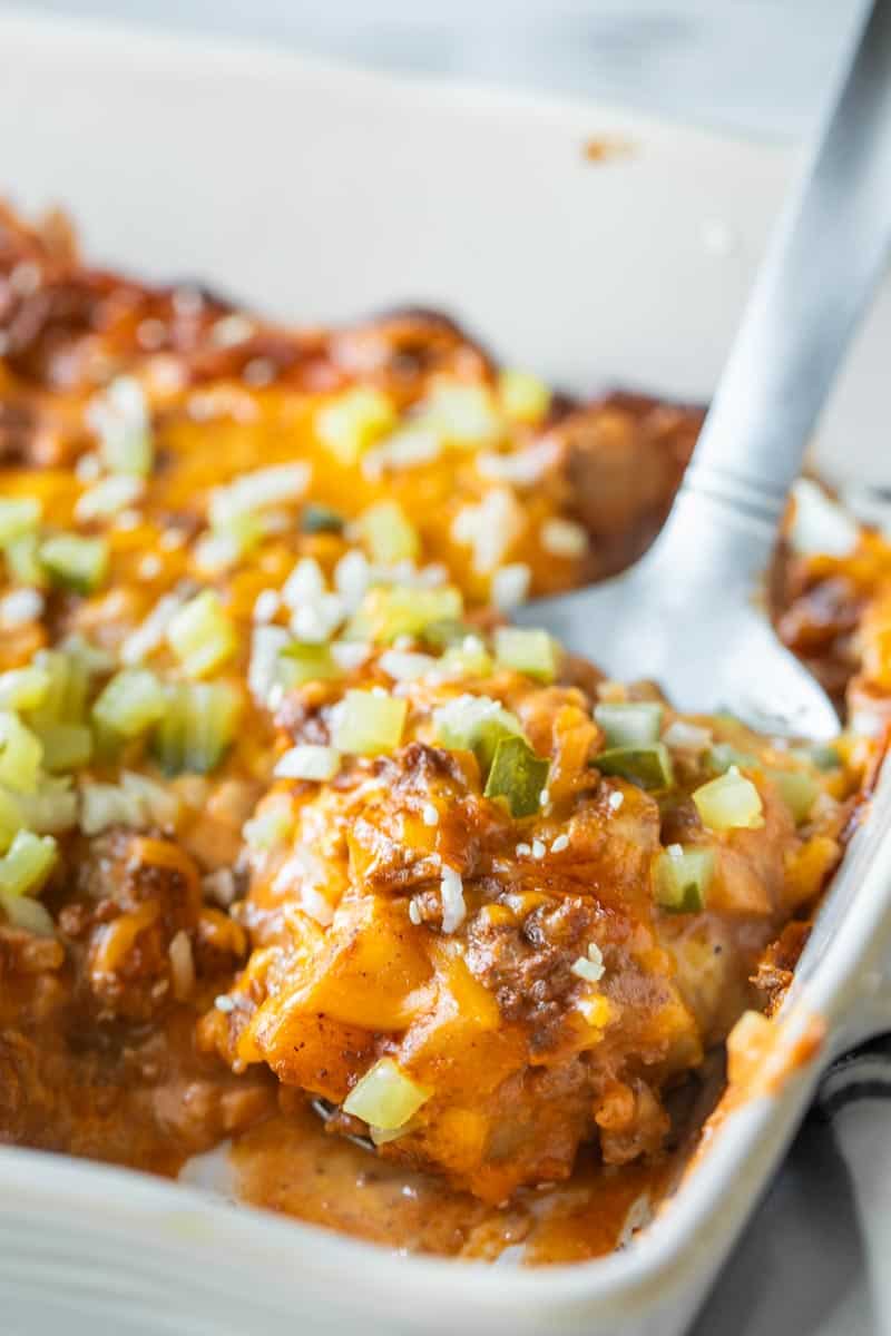 spatula in baking dish with cheeseburger casserole