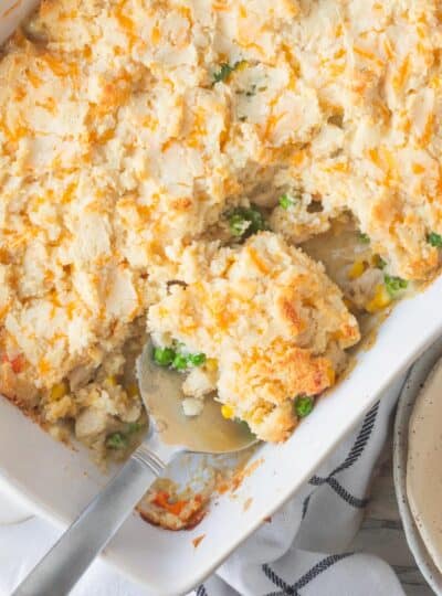 top down view of large spoon in chicken pot pie biscuit casserole