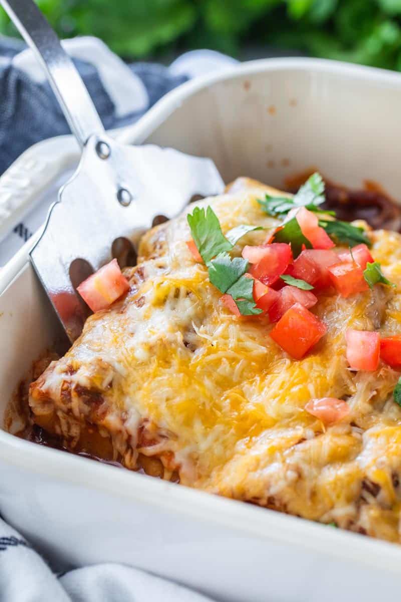 spatula in dish of burrito casserole