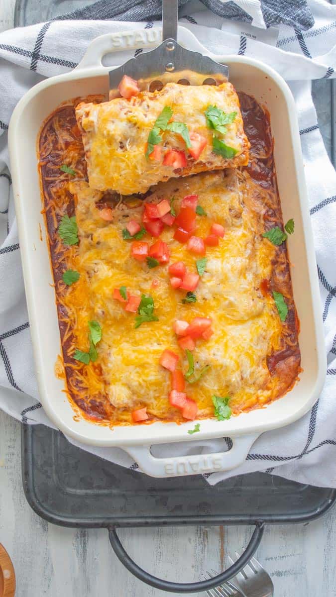 top down view of casserole dish filled with cheesy burritos