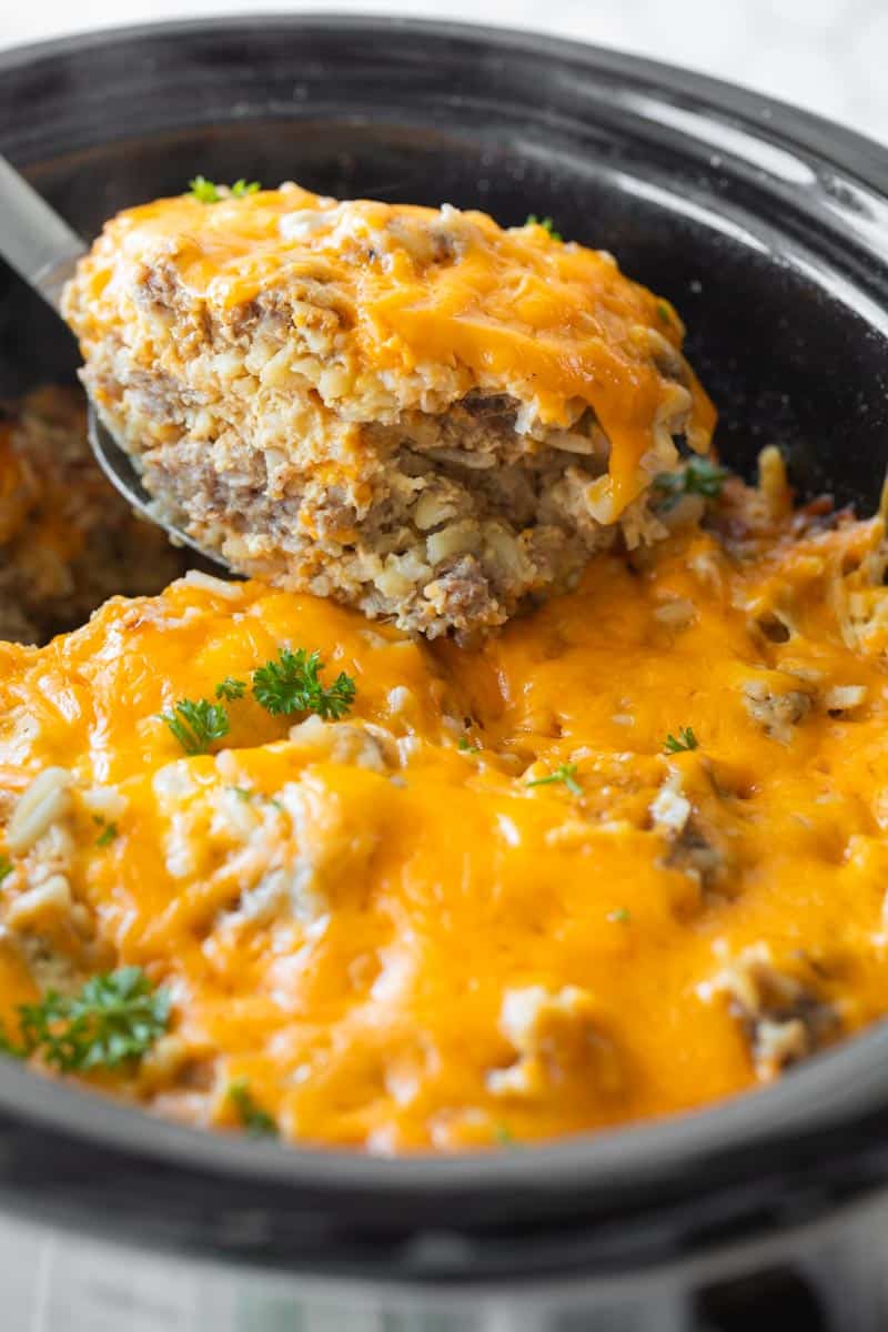 spatula scooping crockpot breakfast casserole