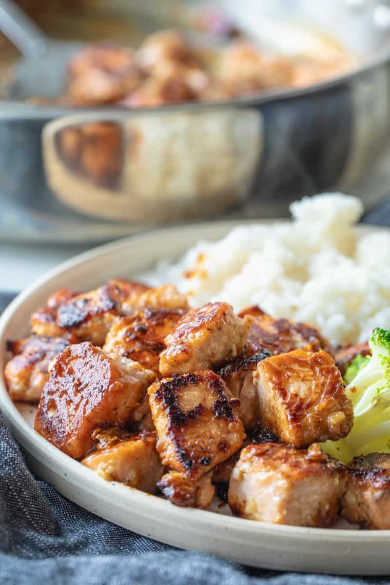 plate filled with rice, broccoliand salmon bites