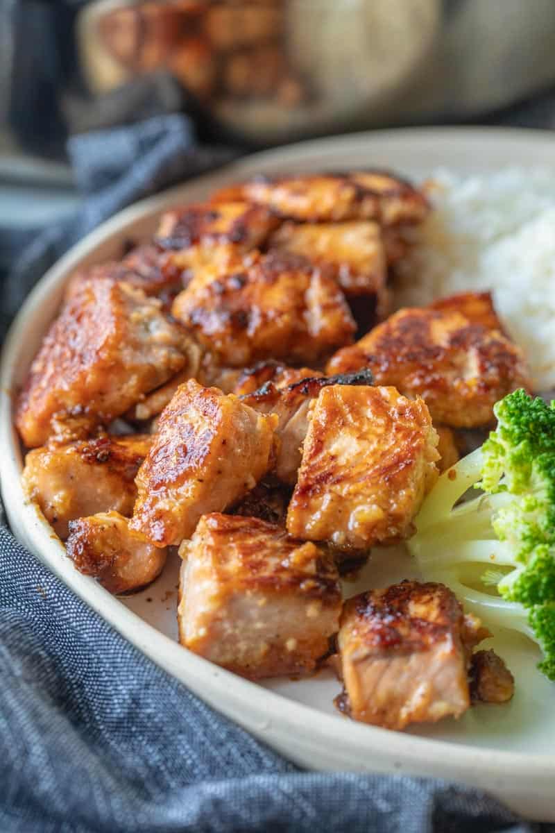 salmon bites on a plate with broccoli florets