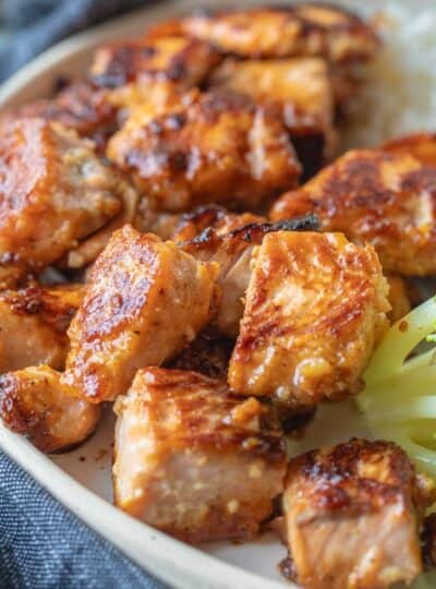 crispy salmon bites on a plate with broccoli