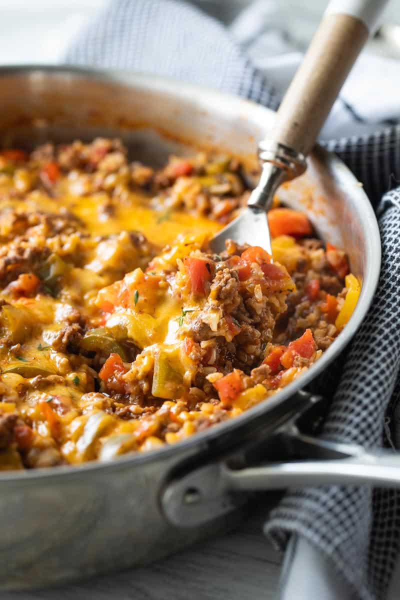 spoon scooping stuffed pepper casserole