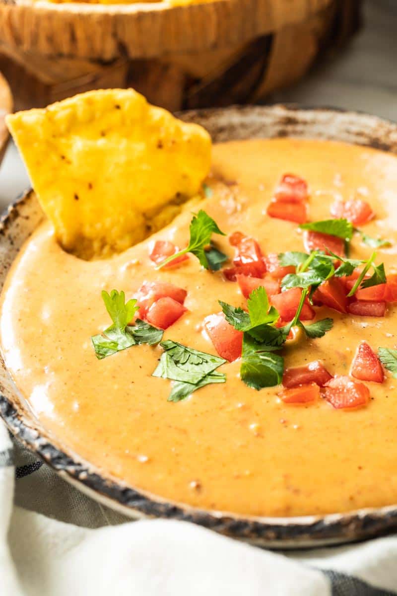 chip in a serving bowl of queso