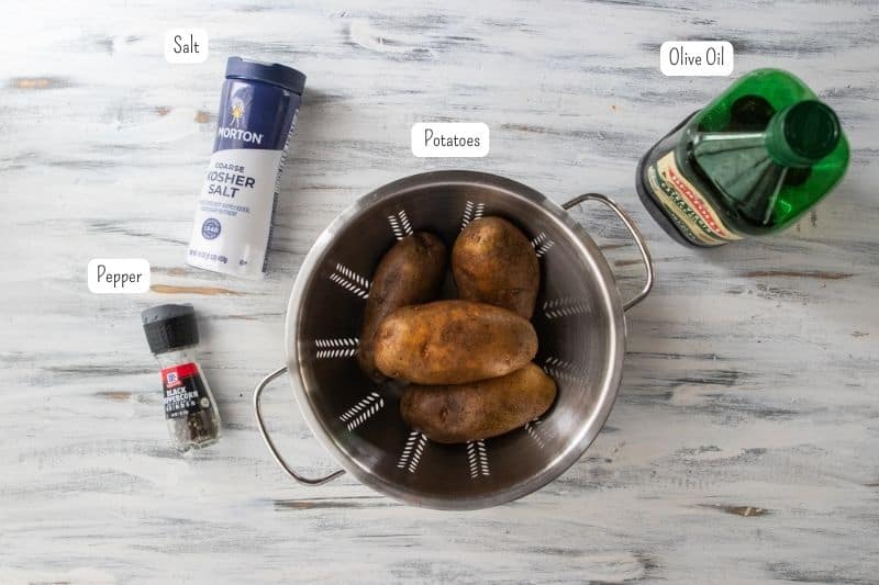 pepper, salt, potatoes and olive oil on a countertop