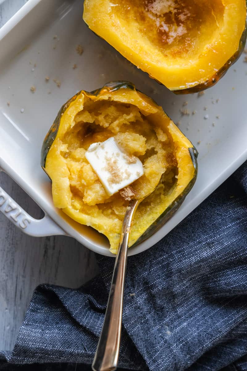 top down view of acorn squash filled with butter and brown sugar