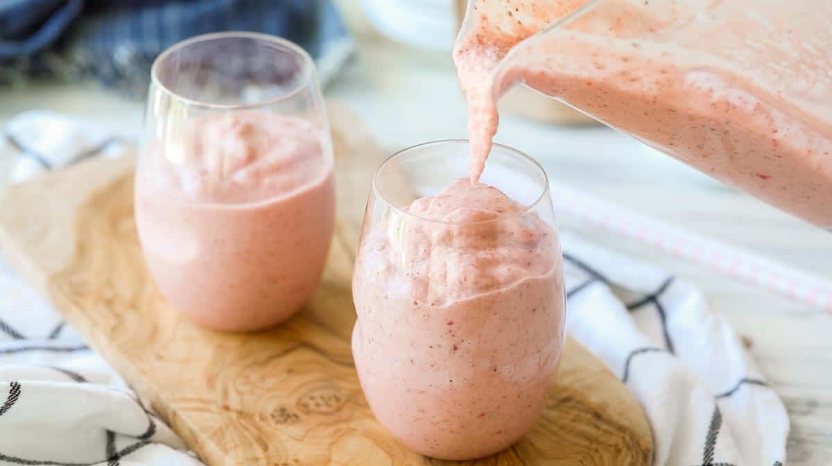 pouring a smoothie into a glass