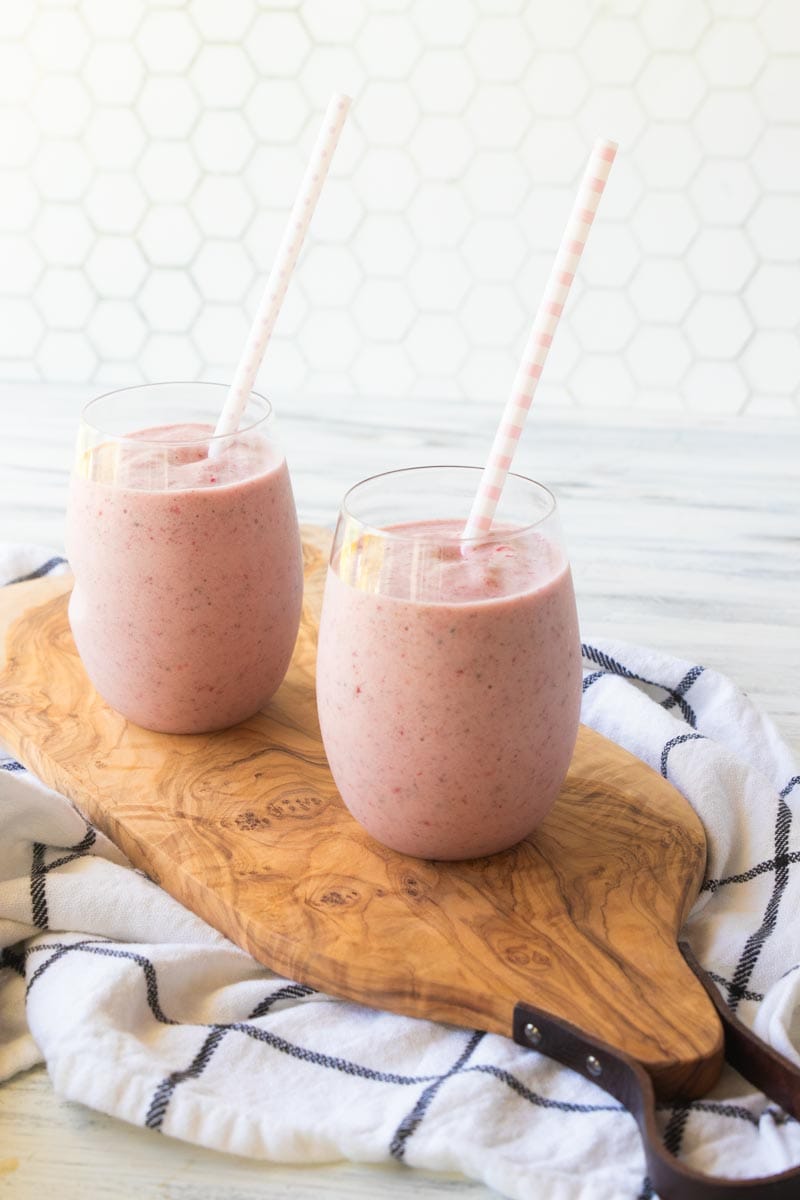 2 protein fruit smoothies in glasses with straws