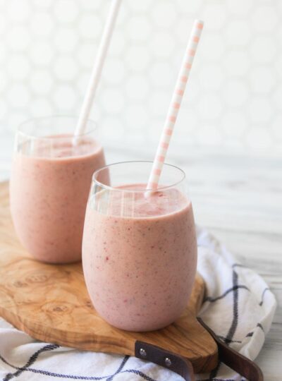 2 protein fruit smoothies in glasses with straws