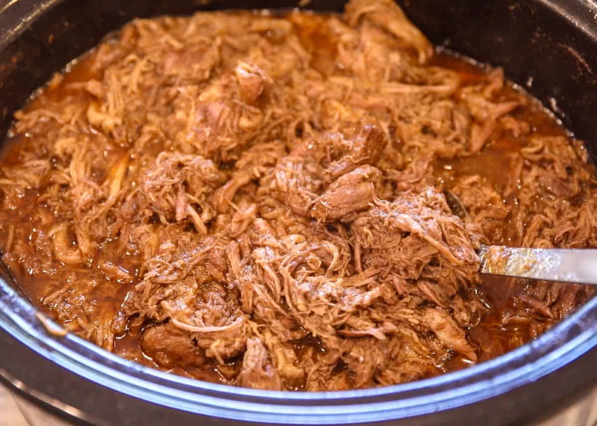 shredded pulled pork in a slow cooker