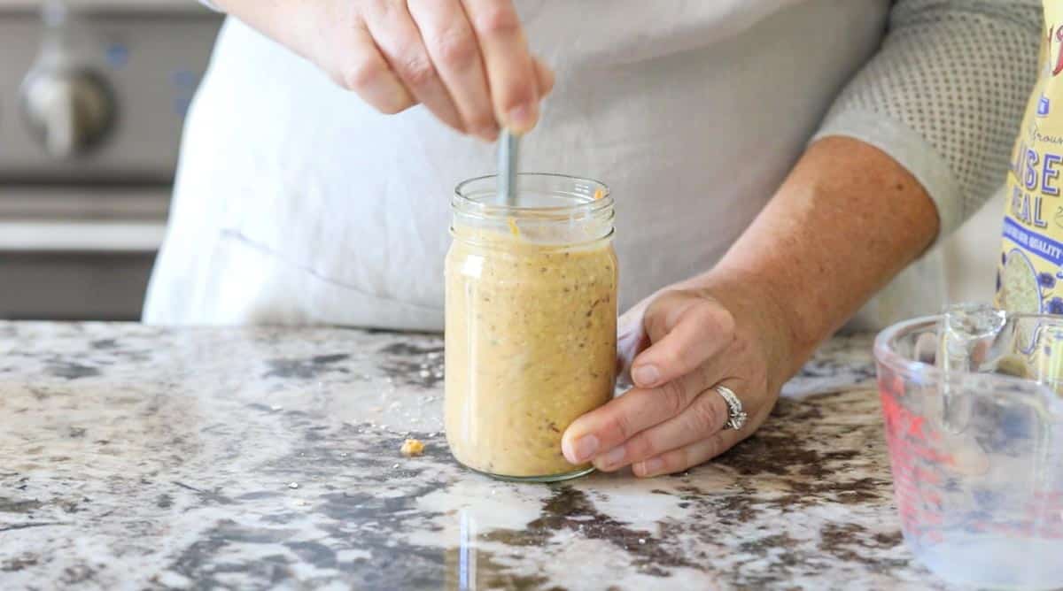 a jar with overnight oats being stirred