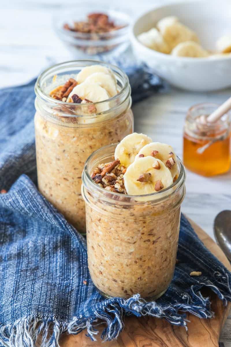 pumpkin overnight oats in a jar with bananas and nuts on top