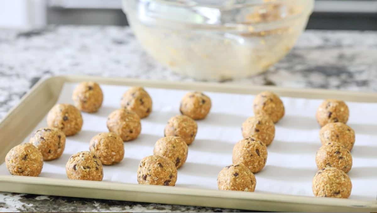 pumpkin protein balls rolled on a baking tray