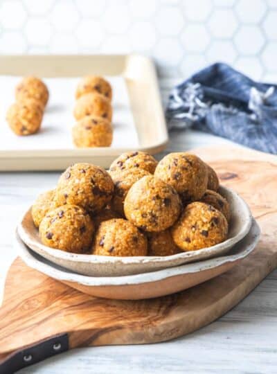 pumpkin protein balls stacked in a bowl
