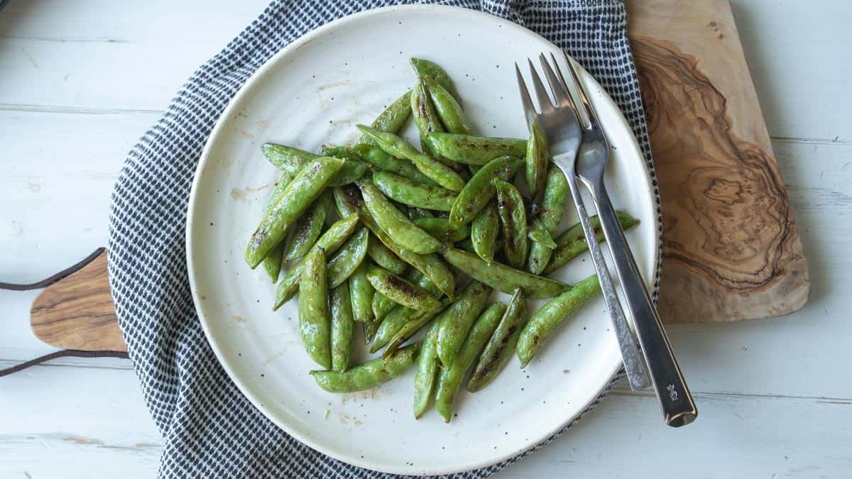 top down view of a plate with roasted pea pods