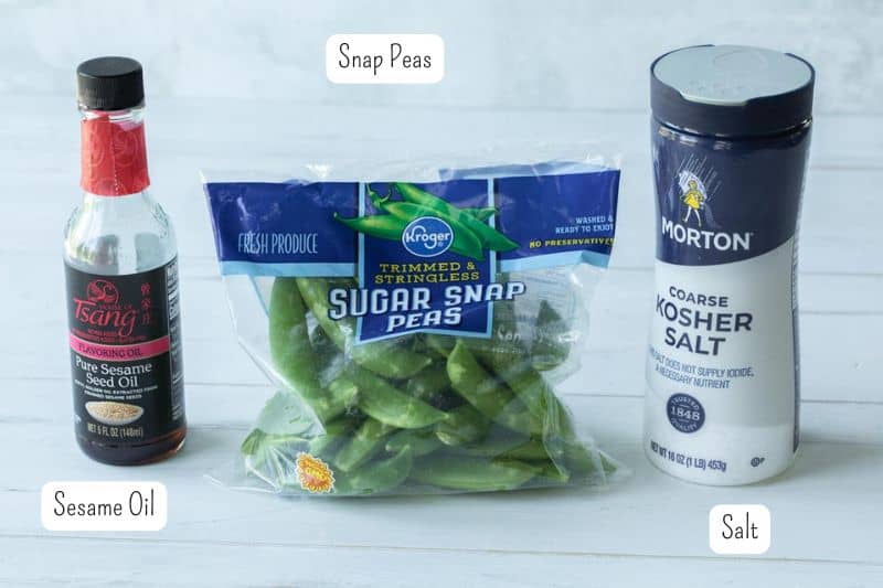 sesame oil, snap peas and salt on a counter