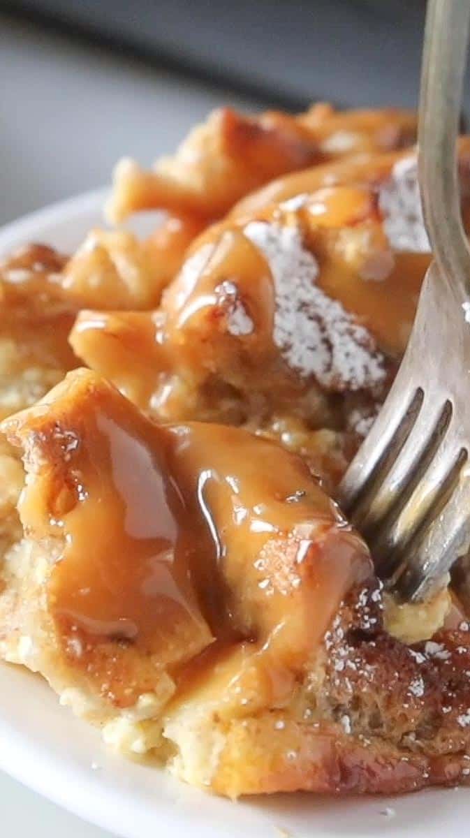 fork scooping into apple bread pudding