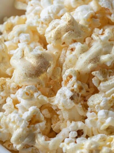 chocolate coated popcorn with edible glitter shown up close in a bowl