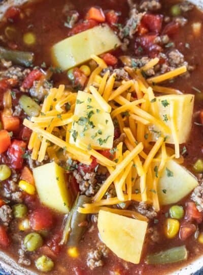 top down view of hamburger soup topped with shredded cheese