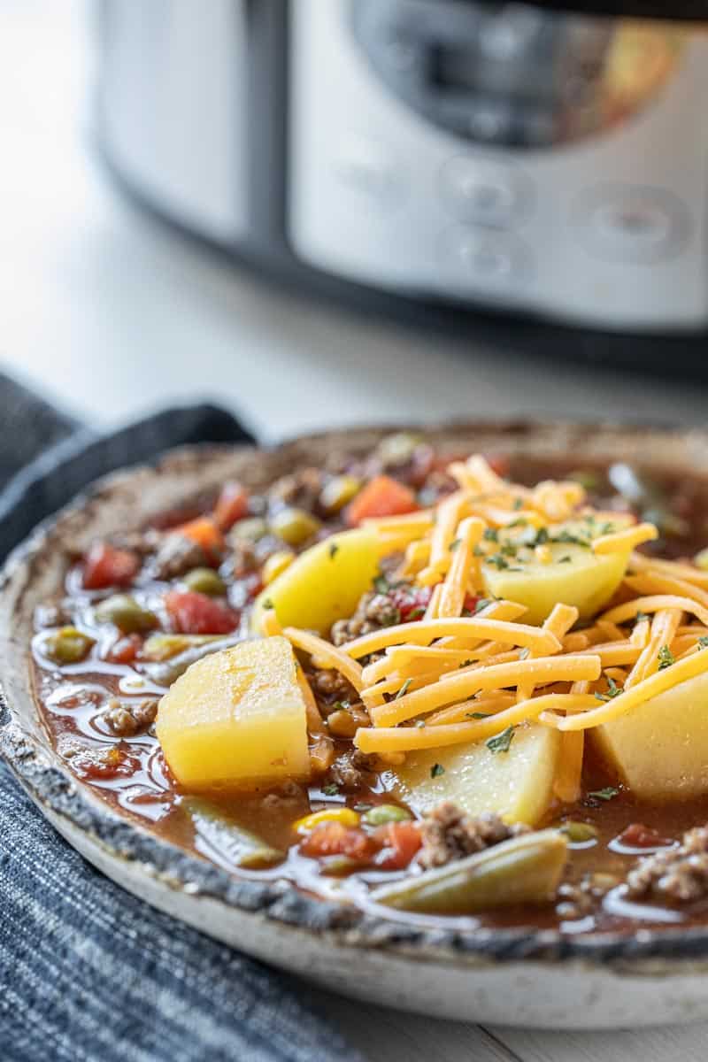 hamburger soup topped with shredded cheese