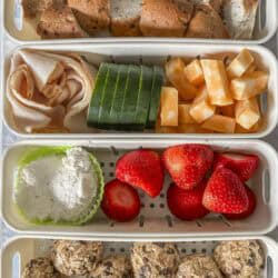 a shot of a 4 compartment snack box with food in ti