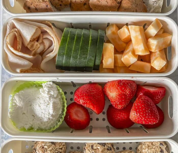 a shot of a 4 compartment snack box with food in ti