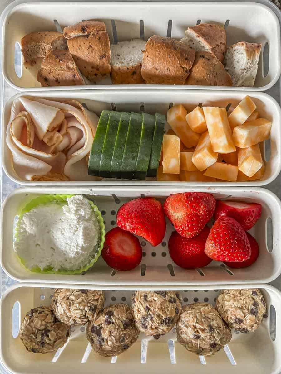 a shot of a 4 compartment snack box with food in ti
