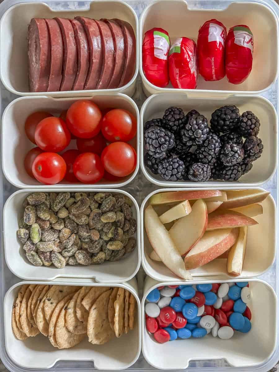 a shot of an 8 compartment snack box with snacks in it